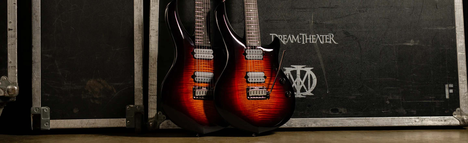 John Petrucci holding the Majesty x DiMarzio 7 guitar in Royal Red.