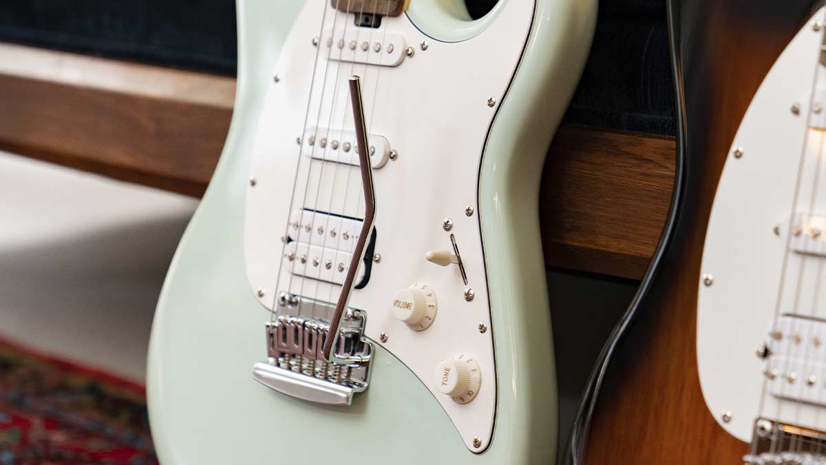 Closeup of a mint green electric guitar