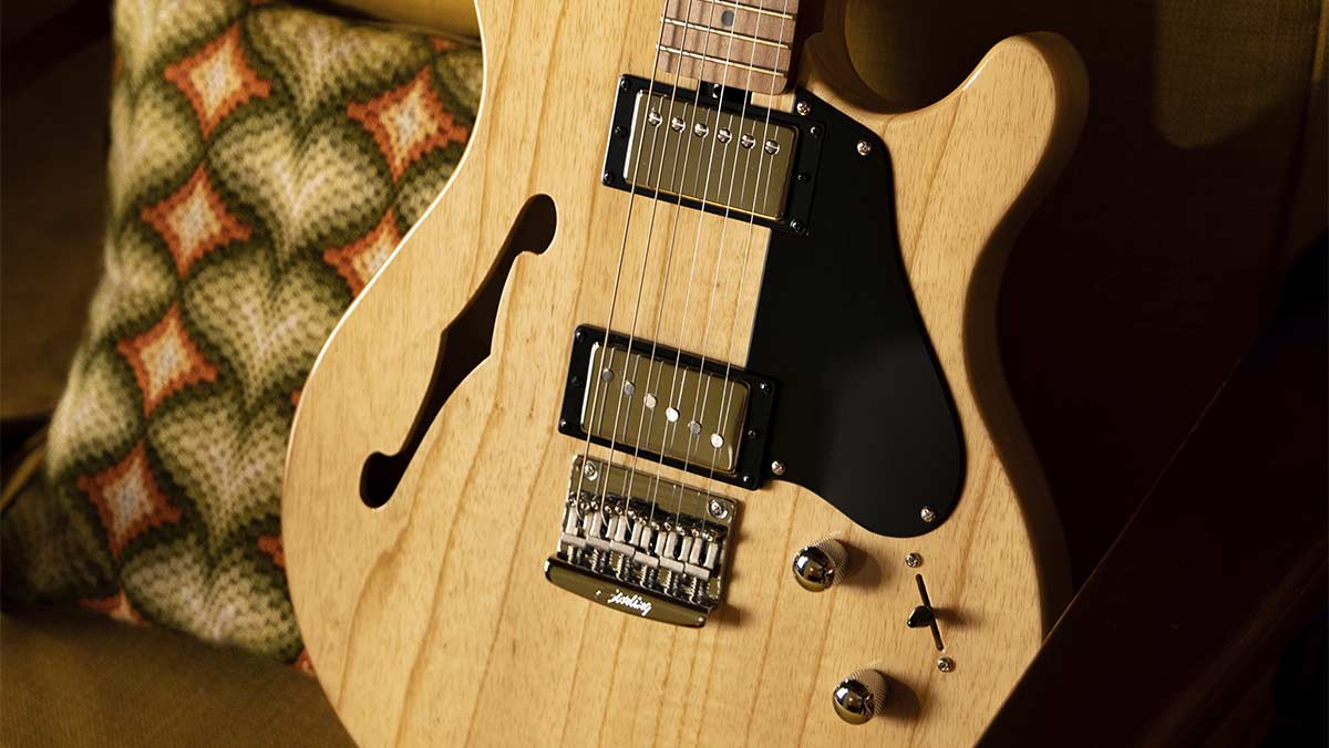 Closeup of a chambered electric guitar in a natural wood finish